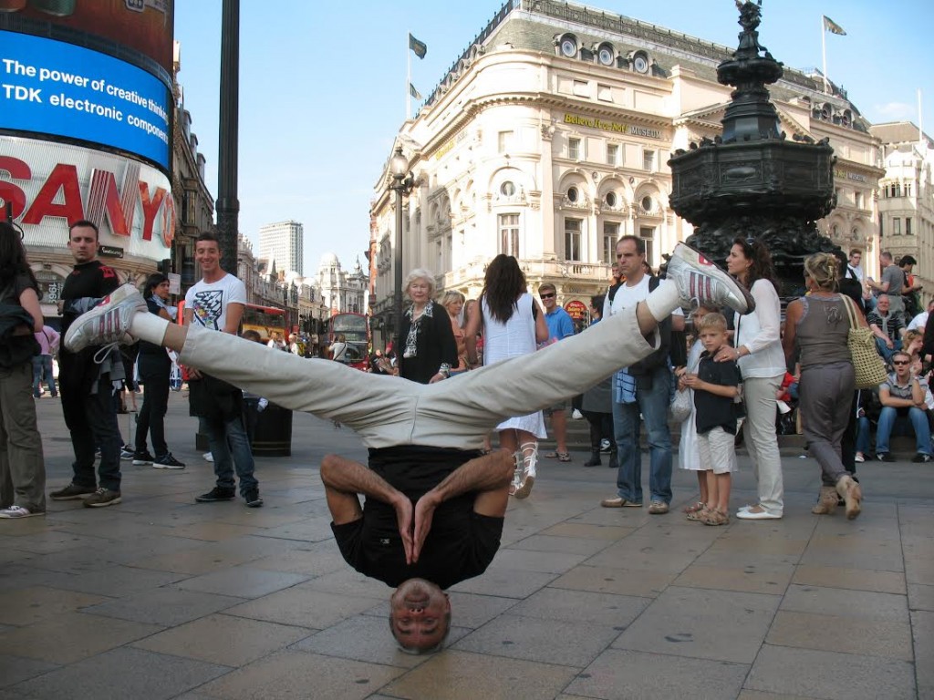 Sri Dharma in London, Summer of 2010. The pose is a variation of Nirlamba Shirshasana -- a hands-free headstand. (Photo/Hugh Herrera)
