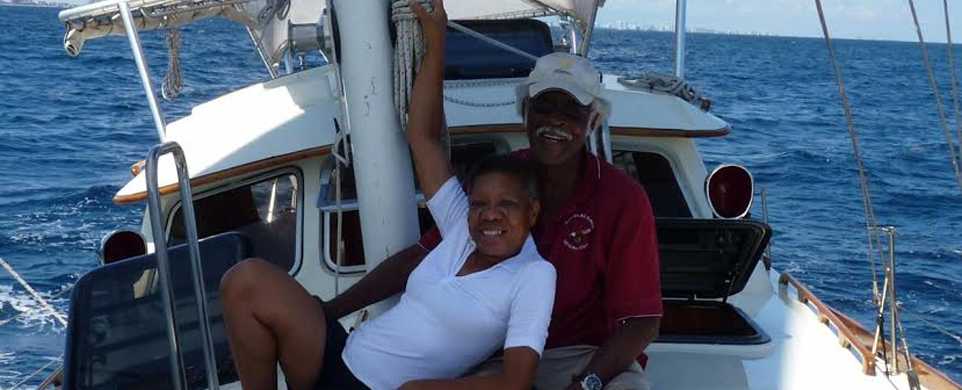 A man and woman sitting on the back of a boat.